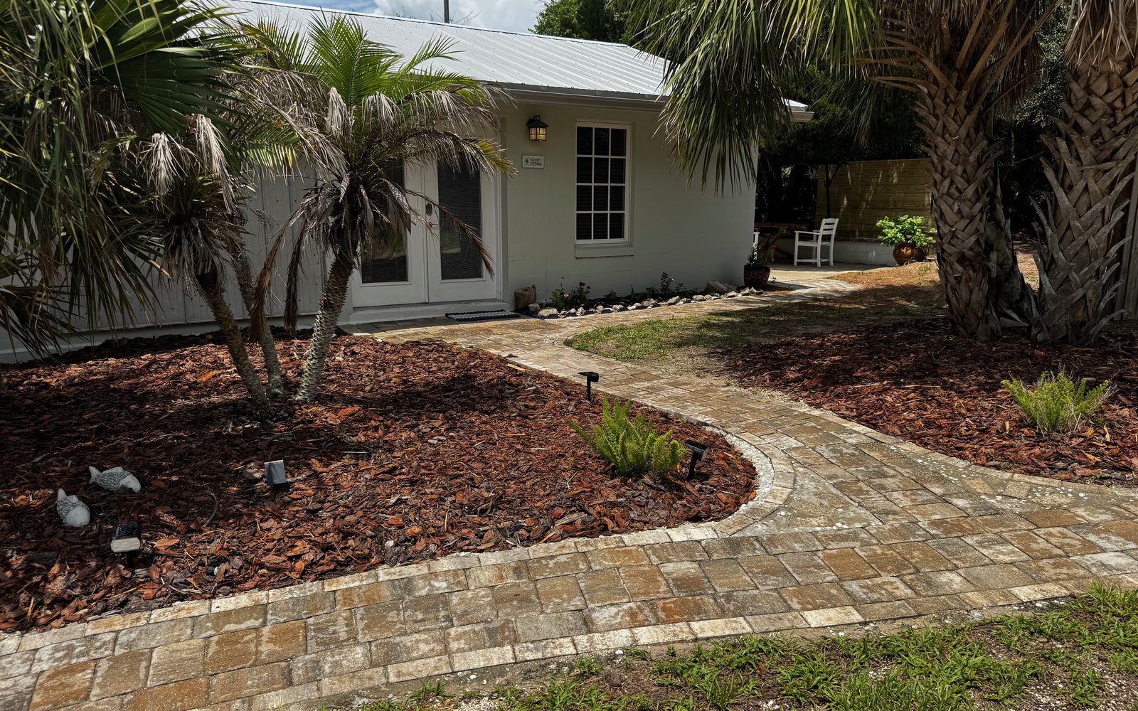 Pelican Cottage exterior and palms at The Silver Sands, Crescent Beach