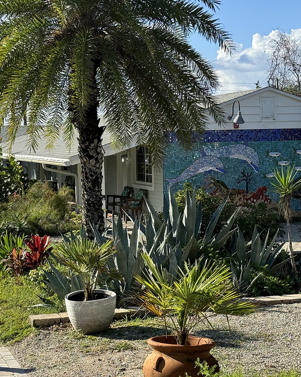 Courtyard mosaic mural and tropical plantings at The Silver Sands, Crescent Beach Florida